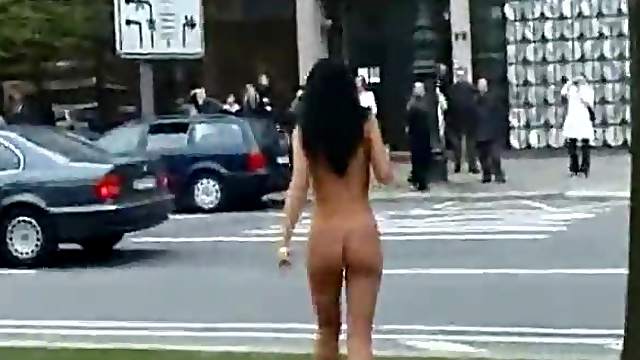 Girl walks around busy city streets naked