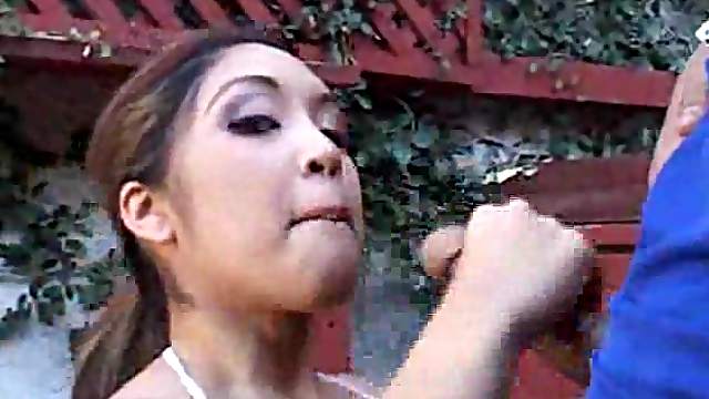 Hot Asian chick does oral outdoors