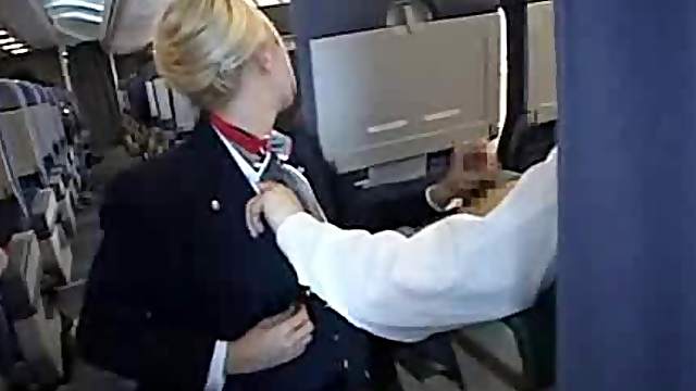 Naughty flight attendant giving a blowjob