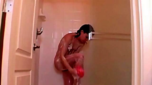 Teen with a nice bush soaps up in the shower