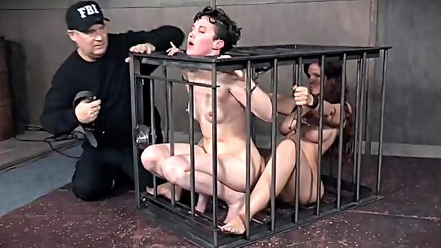 Girls in a cage together submit to BDSM pain