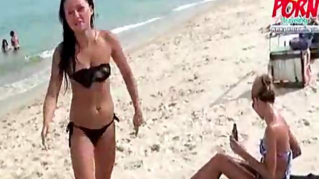 Bikini babes rub lotion on each other
