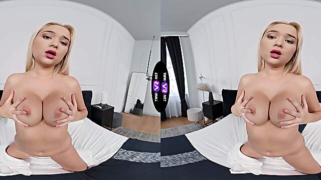 Blond bombshell Jessie teases with her fakes in a steamy VR session